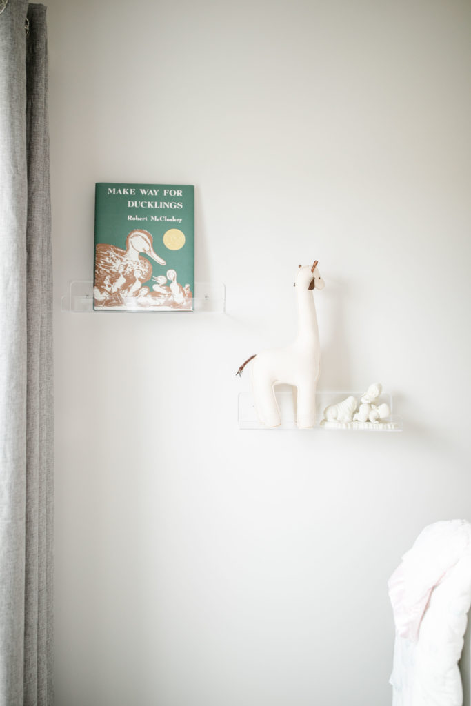Nursery room details with ugly duckling book and felt giraffe